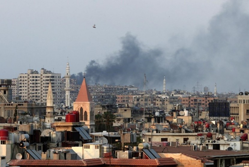 Columns of smoke rising from heavy shelling in the Jobar neighborhood in west Damascus, Syria, Thursday, Aug. 22, 2013. 