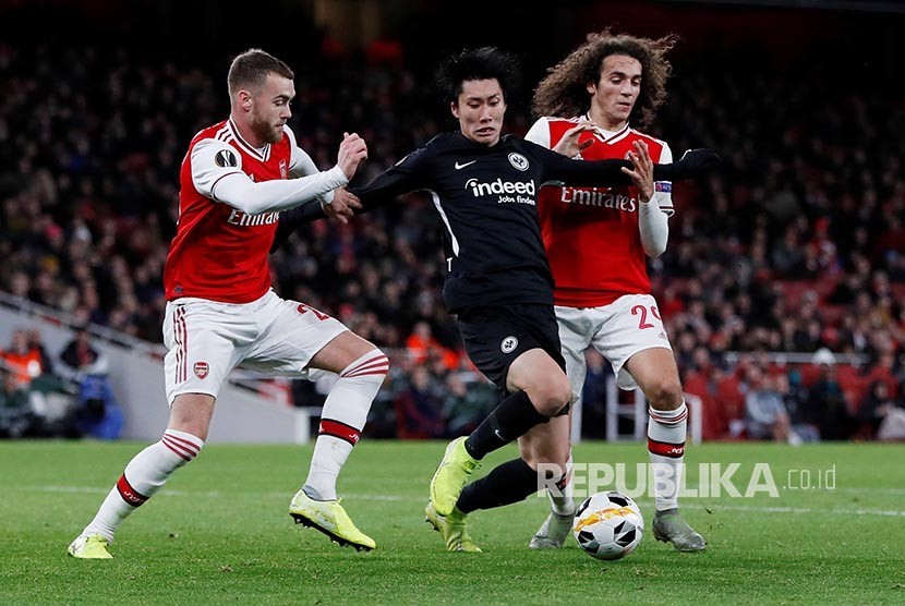 Daichi Kamada diadang dua pemain Arsenal pada laga Liga  Europa Grup  F antara Arsenal melawan Eintracht Frankfurt di Emirates Stadium,  London, Jumat, (29/11) dini hari.