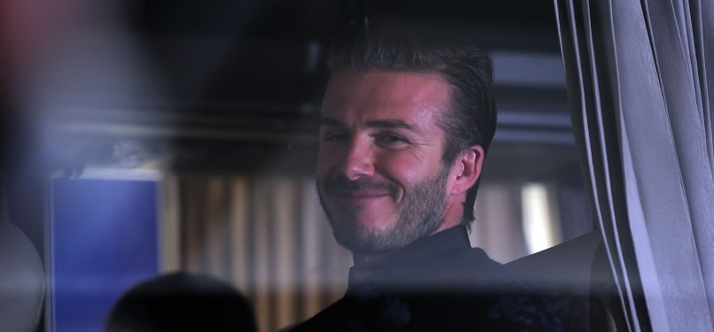 David Beckham tersenyum dari dalam bis rombongan LA Galaxy di Bandara Soekarno Hatta, Tangerang, Banten, Senin (28/11).