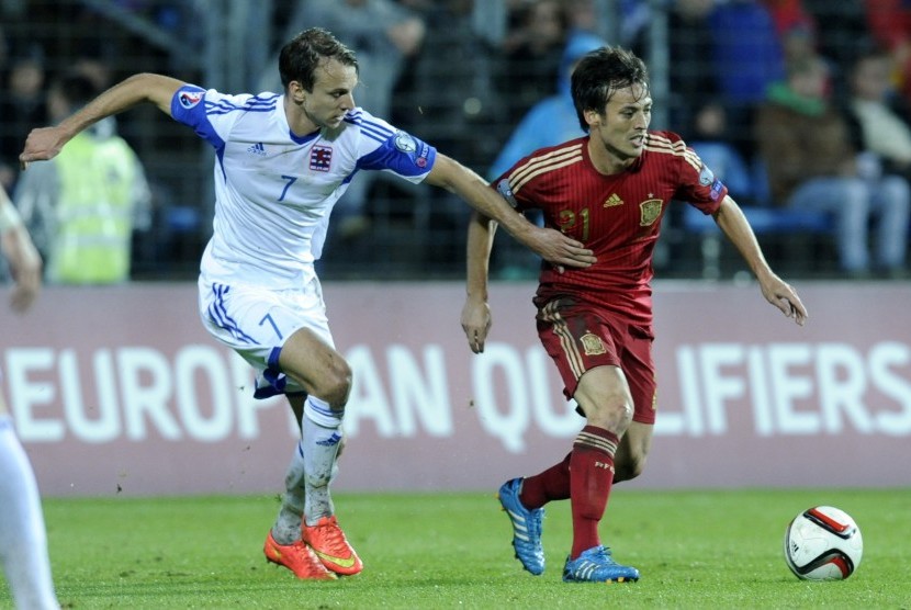 David Jimenez Silva of Spain (R) fights for the ball with Lars Gerson of Luxembourg (R) during their Euro 2016 qualification soccer match at the Josy Barthel stadium in Luxembourg October 12, 2014.