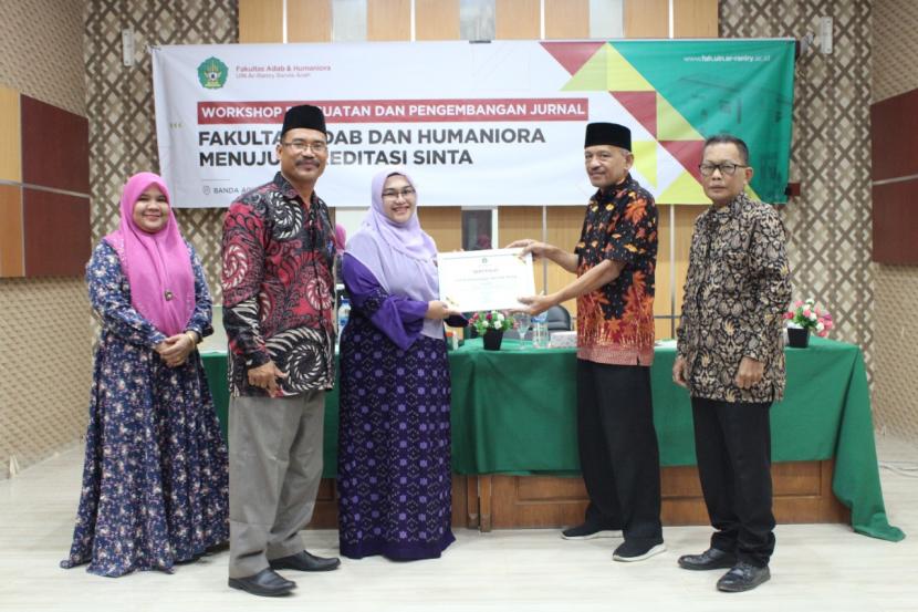 Dekan Fakultas Adab dan Humaniora UIN Ar-Raniry Banda Aceh, Dr Fauzi Ismail MSi menyerahkan sertifikat kepada Prof Dr Yunisrina Qismullah Yusuf Mling selaku narasumber Workshop Penguatan dan Pengembangan Jurnal Menuju Akreditasi SINTA, Rabu (20/7/2022) di Aula Mini fakultas tersebut.