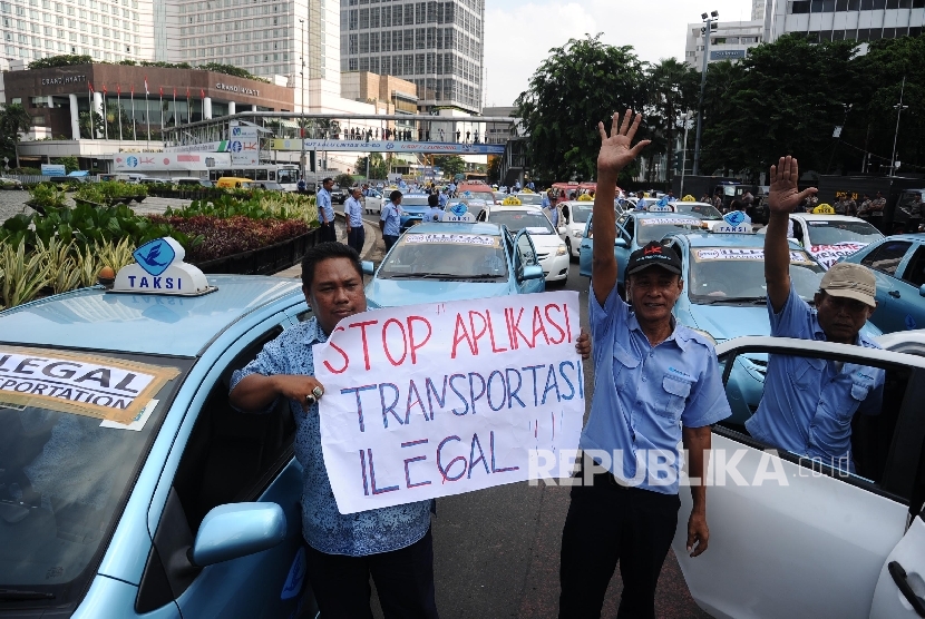 Demonstran tergabung dalam Paguyuban Pengemudi Angkutan Darat (PPAD) melakukan aksi unjukrasa saat melintas di Bundaran HI, Jakarta, Selasa (22/3).