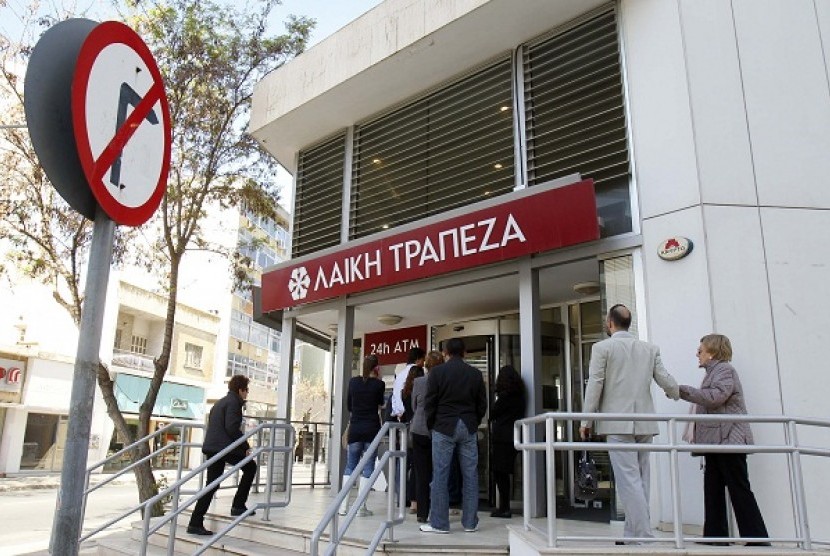 Depositors wait to enter a branch of Laiki Bank in Nicosia March 29, 2013. Cyprus claims it has 
