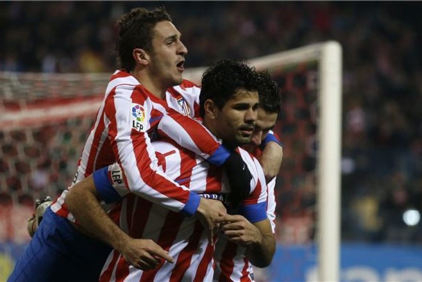 Diego Costa (tengah), pemain Atletico Madrid, merayakan golnya bersama rekan setim saat menghadapi Sevilla di leg pertama babak semifinal Piala Raja Spanyol di Vicente Calderon, Madrid, Kamis (31/1). 