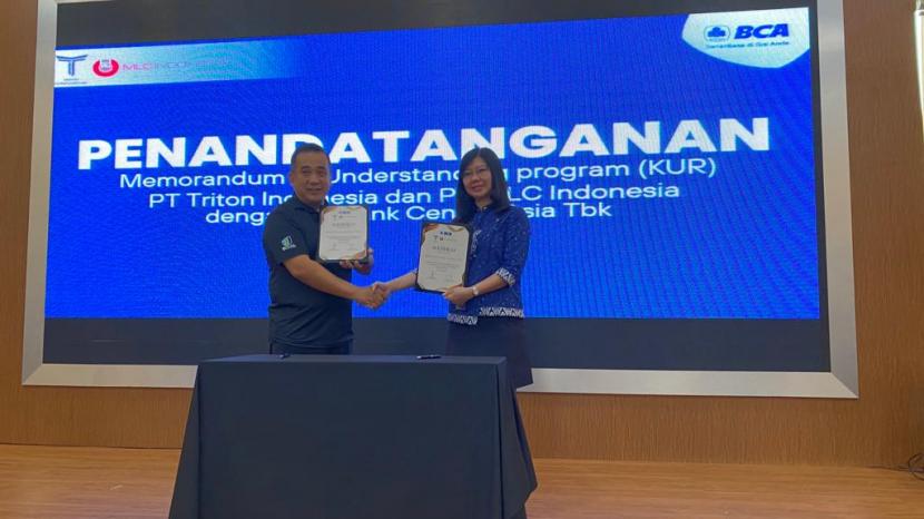 Director PT Triton Internasional, Rizal Matulatan dan Kepala Pengembangan Bisnis BCA KCU Alam Sutera, Agustina Hadiwijaya, menandatangani Memorandum of Understanding program penyaluran kredit usaha rakyat (KUR), Selasa (21/3/2023). 