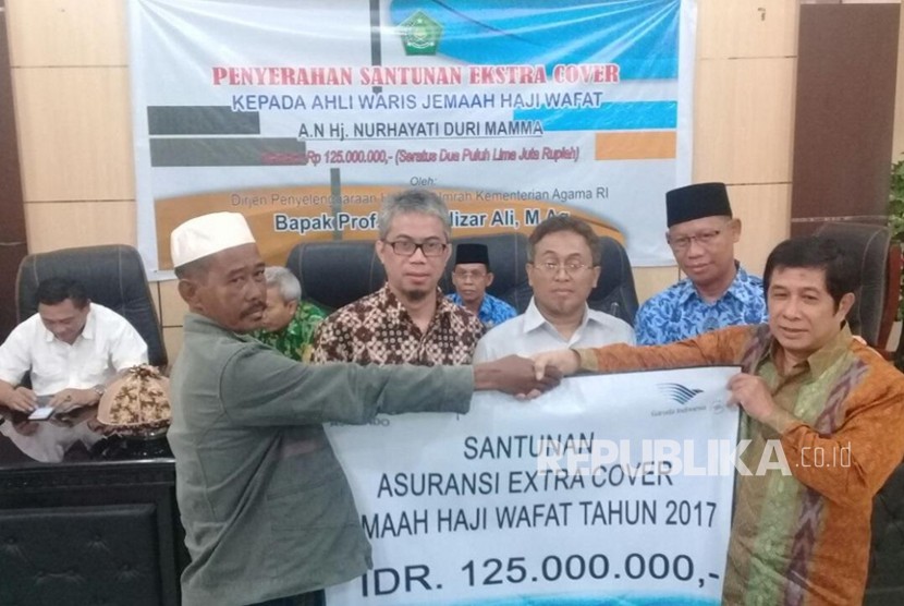  Direktur Layanan Haji Dalam Negeri Ahda Barori menyerahkan Santunan Ekstra Cover dari Garuda Indonesia kepada keluarga jamaah