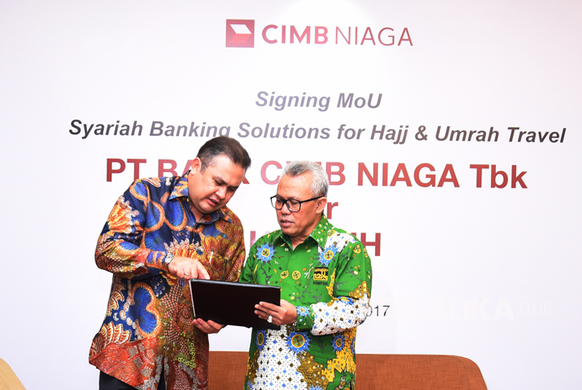 Direktur Syariah Banking CIMB Niaga Pandji P. Djajanegara (kiri) berbincang dengan Ketua Umum Himpunan Penyelenggara Umrah dan Haji Khusus (HIMPUH) H. Baluki Ahmad usai penandatanganan Memorandum of Understanding di Jakarta, Rabu (12/4).