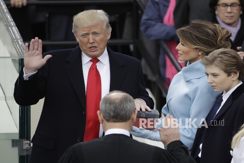 Donald Trump is sworn in as the 45th president of the United States by Chief Justice John Roberts as Melania Trump looks on during the 58th Presidential Inauguration at the U.S. Capitol in Washington, Friday, Jan. 20, 2017.