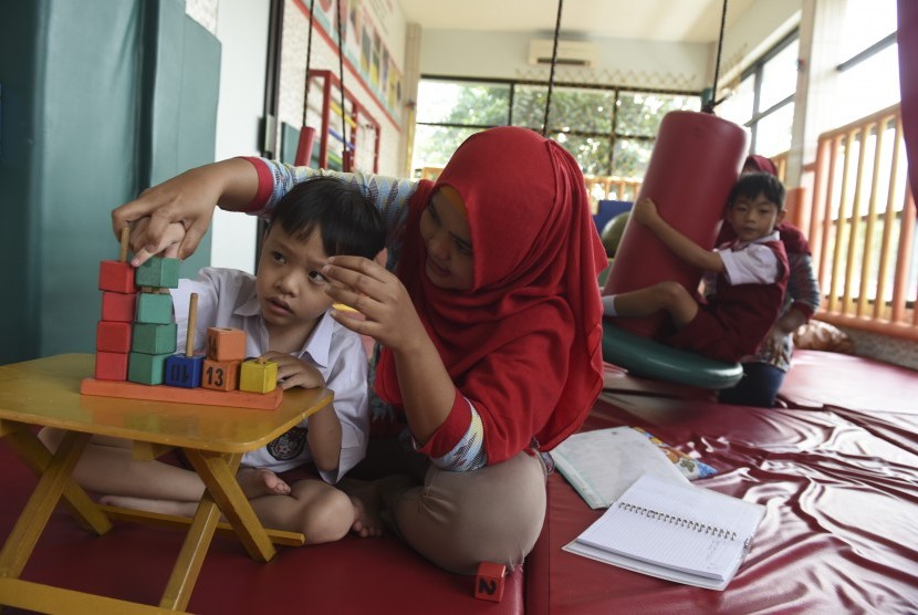 Dua anak berkebutuhan khusus menjalani terapi di Sekolah Inklusif Galuh Handayani Surabaya, Jawa Timur, Rabu (18/1). 