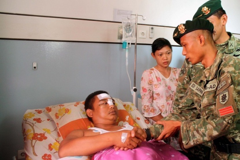 Dua anggota Yonif Linud 305/Tengkorak Telukjambe menjenguk salah seorang anggota Polres Karawang (kiri) yang menjadi korban peristiwa bentrokan antara TNI-Brimob, di Rumah Sakit Cito Karawang, Jabar, Rabu (20/11).