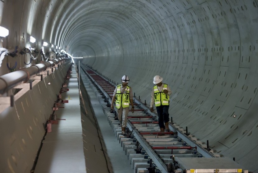 Dua orang pekerja melakukan pemeriksaan pemasangan rel di terowongan proyek Mass Rapid Transit (MRT) Stasiun Bundaran Hotel Indonesia di Jakarta, Kamis (26/10).