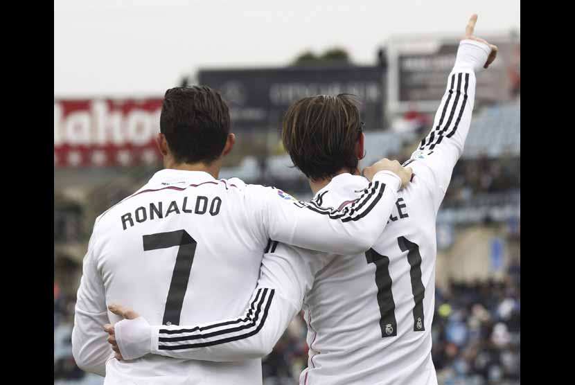 Dua pemain termahal Real Madrid, Gareth Bale (kanan) dan Cristiano Ronaldo, melakukan selebrasi usai menjebol gawang Getafe dalam laga lanjutan La Liga Spanyol di Stadion Alonso Perez, Getafe, Ahad (18/1).