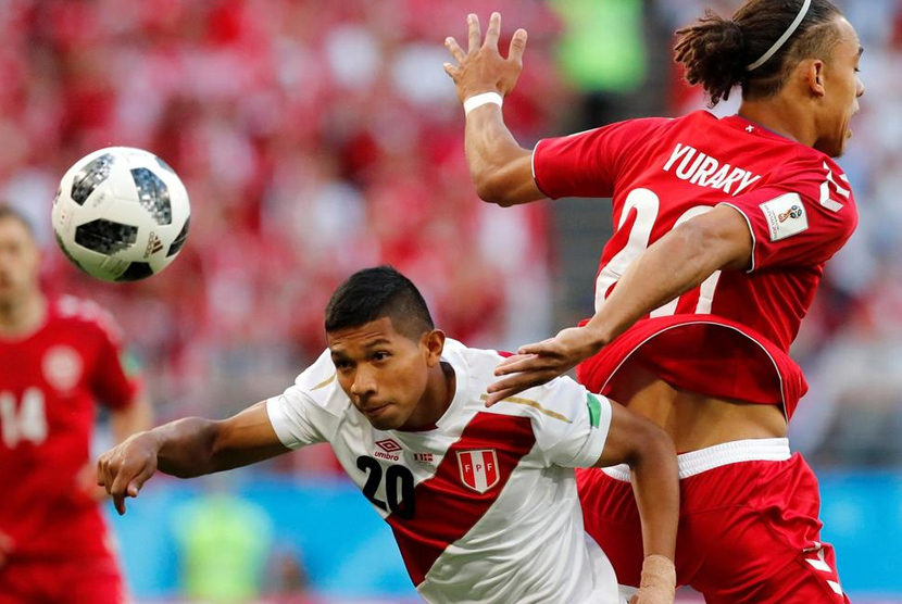 Edison Flores (Peru) berebut bola dengan pemain Timnas Denmark Yussuf Poulsen.