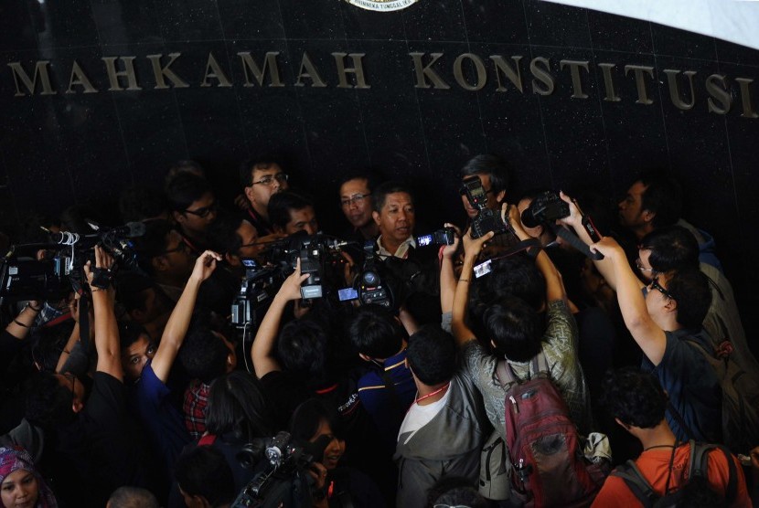 Effendi Gazali (tengah) menjawab pertanyaan media usai pembacaan putusan di Mahkamah Konstitusi (MK), Jakarta, pada 23 Januari 2014. MK kala itu mengabulkan pemilu serentak pileg dan pilpres, pada Pemilu 2019 yang permohonannya diajukan oleh Koalisi Masyarakat Sipil untuk Pemilu.