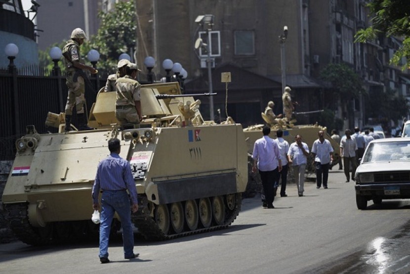 Egyptian military soldiers stand guard atop armored personnel carriers at Maspero, an Egypt's state tv and radio station in Cairo, on Saturday.