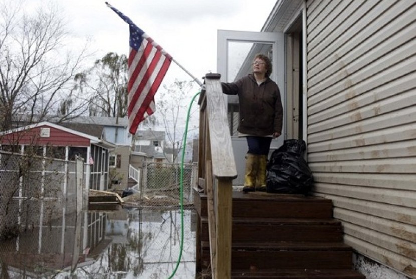 Eileen Miley takes a break from cleaning her home that was destroyed by flooding during Storm Sandy in Staten Island, New York, Thursday, Nov. 1, 2012.   