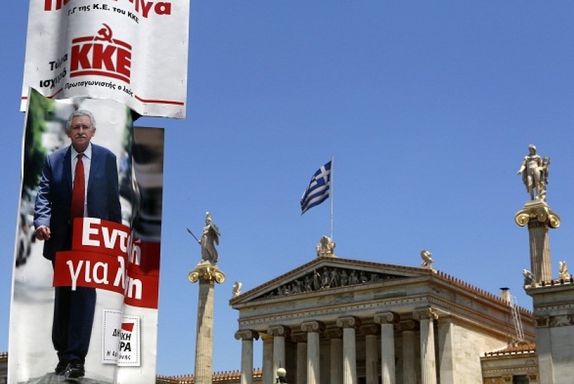 Election campaign posters of Democratic Left and Greece's Communist Party are seen next to the Athens Academy and statues of ancient Greek gods June 13, 2012. Greece holds general parliamentary elections on June 17. European crisis is one of the main theme