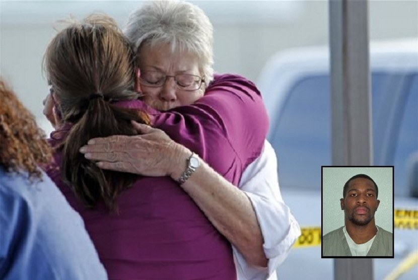 Employees and friends wait behind a tape for word of loved ones as police investigate an incident at Vaughan Foods on Thursday, Sept. 25, 2014 in Moore, Oklahima. (isert: Alton Nolen)