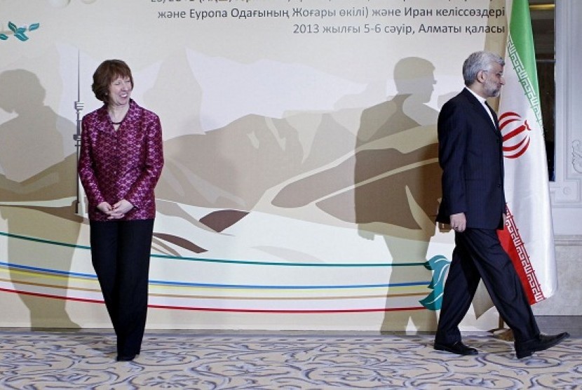 EU foreign policy chief Catherine Ashton, left, smiles, as Secretary of Iran’s Supreme National Security Council Saeed Jalili walks away, after a photo call at a start of high-level talks between world powers and Iranian officials in Almaty, Kazakhstan on 
