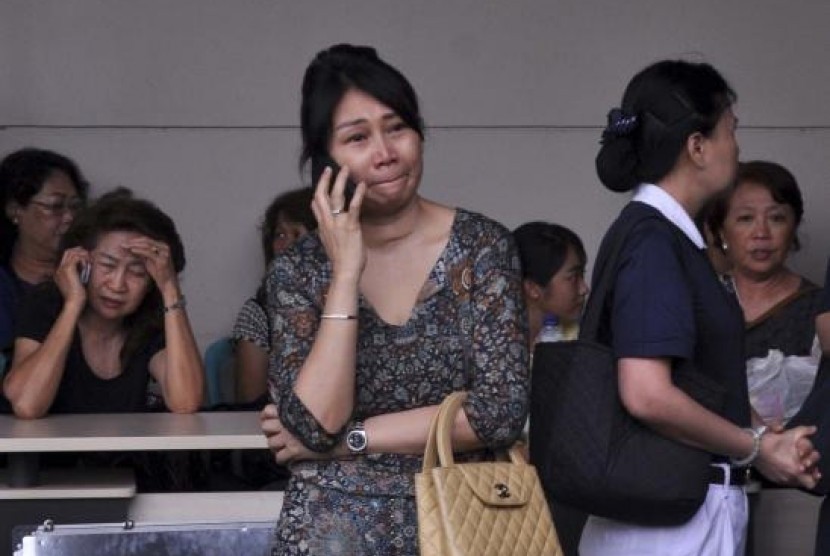 Family members of passengers on board AirAsia flight QZ8501 wait for information inside the AirAsia crisis centre at Juanda Airport in Surabaya, East Java December 28, 2014.