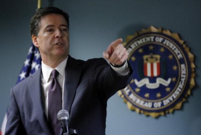 FBI Director James Comey takes a question from a reporter during a news conference at the FBI office in Boston, Massachusetts November 18, 2014.