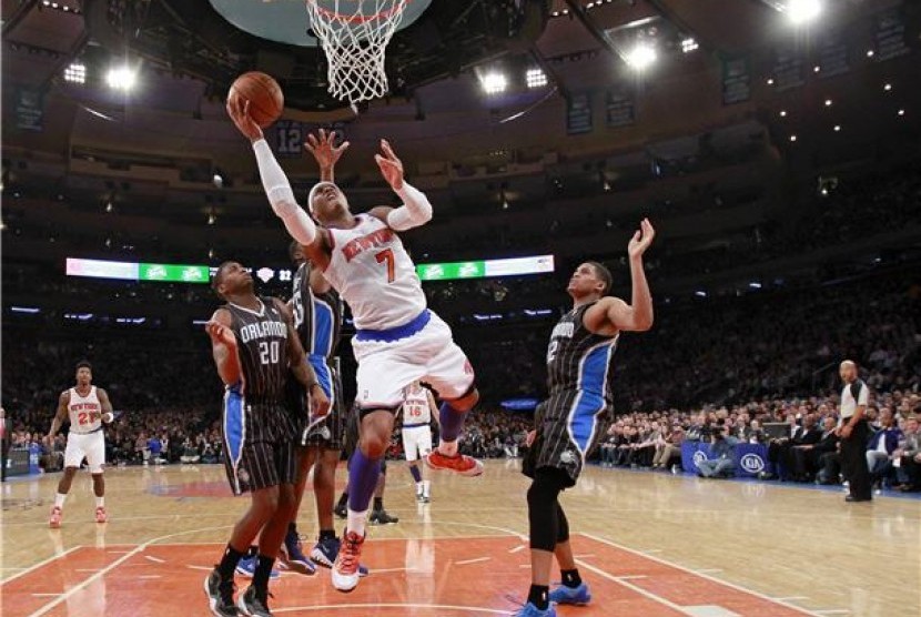 Forward New York Knicks, Carmelo Anthony (tengah), melakukan drives di bawah kepungan pemain Orlando Magic, DeQuan Jones (kiri) dan Tobias Harris, dalam laga NBA di Madison Square Garden, New York, Rabu (20/3) 