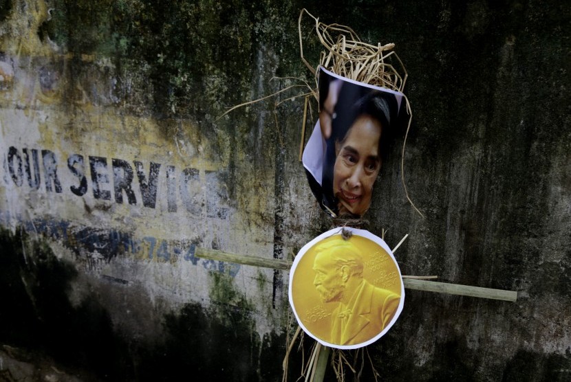Foto Aung San Suu Kyi ditempatkan di dinding sebelum dibakar oleh aktivis organisasi ultra-kiri dalam aksi demonstrasi menentang penganiayaan Muslim Rohingya, di Kolkata, India, Senin (4/9).
