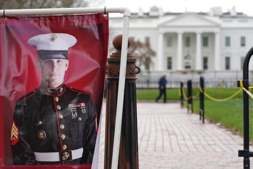 Foto poster veteran Korps Marinir AS dan tahanan Rusia Trevor Reed berdiri di Taman Lafayette dekat Gedung Putih, 30 Maret 2022, di Washington.