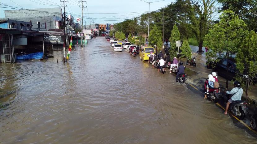 Foto udara kendaraan warga antre melewati banjir di Jalan Basuki Rahmat Kota Sorong, Papua Barat, Rabu (24/8/2022). Pada hari kedua terjadinya bencana tersebut, sejumlah ruas jalan utama Kota Sorong masih terendam banjir. 