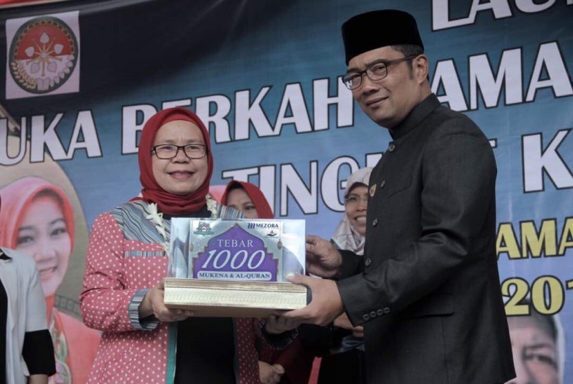 Founder Shafira Corporation Feny Mustafa menyerahkan bantuan 1.000 mukena dan Alquran secara simbolis kepada Wali Kota Bandung Ridwan Kamil dalam kegiatan 'Buka Berkah' Ramadhan di Kota Bandung, belum lama ini.  