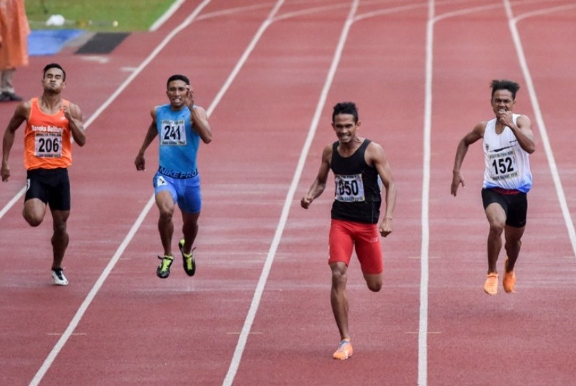 Fuad Ramadhan (kedua kanan) finis tercepat dalam lomba lari 400 meter putra PON XIX.