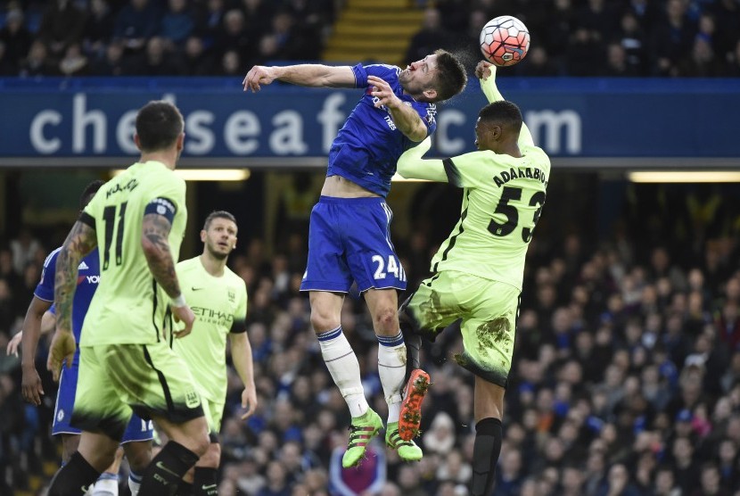 Gary Cahill sedang pemain Manchester City Oluwatosin Adarabioyo sedang berebut bola di udara 