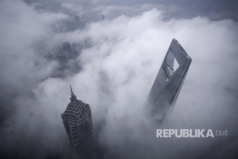 Gedung pencakar langit Shanghai World Financial Center (kanan) and Jin Mao Tower (kiri) tampak saat hujan di kawasan bisnis Pudong, Shanghai, China (ilustrasi). Sekitar 400 karyawan perusahaan multinasional Jerman kembali ke China seiring mulai kembali bergeraknya ekonomi China.