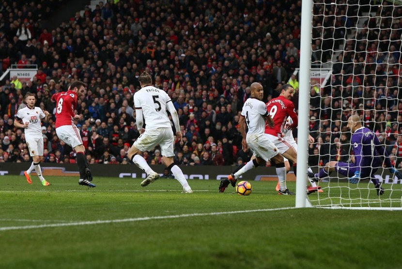 Gelandang Manchester United, Juan Mata (kedua kiri) menembak bola ke arah gawang Hull City pada laga Liga Primer di Old Trafford, Sabtu (11/2). United sementara unggul 1-0.