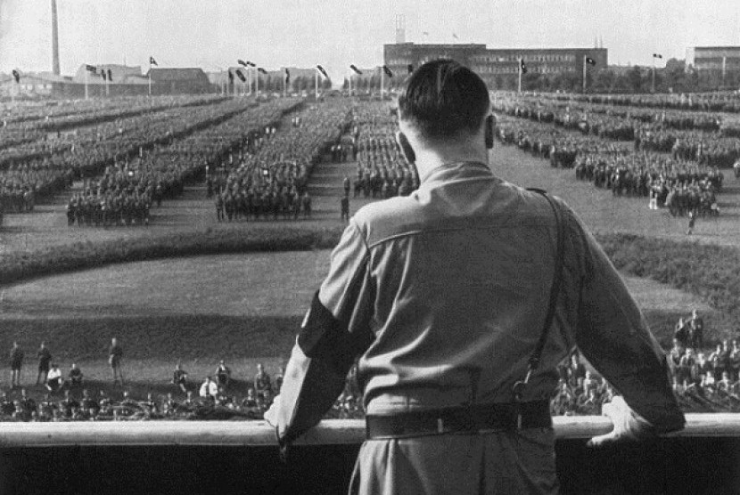 German Fuhrer and Nazi leader Adolf Hitler (1889 - 1945) addresses soldiers with his back facing the camera at a Nazi rally in Dortmund, Germany. 
