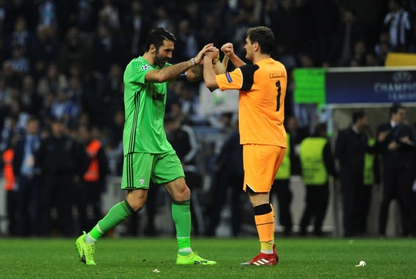 Gianluigi Buffon (kiri) dan Iker Casillas seusai laga Juventus vs FC Porto di Liga Champions.