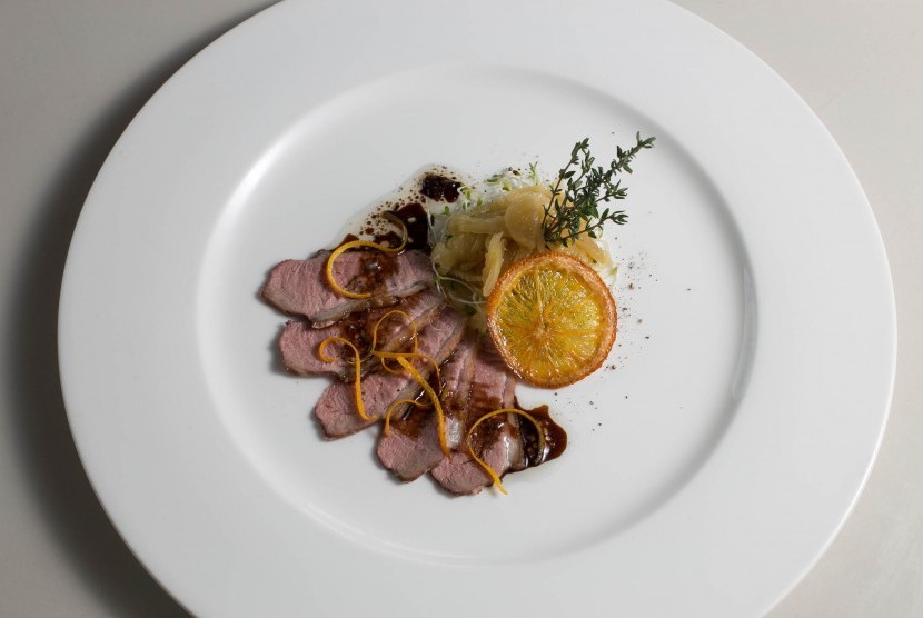 Grilled Pink Duck breast served with Orange-Charlotte Gravy on Fennel Comfit