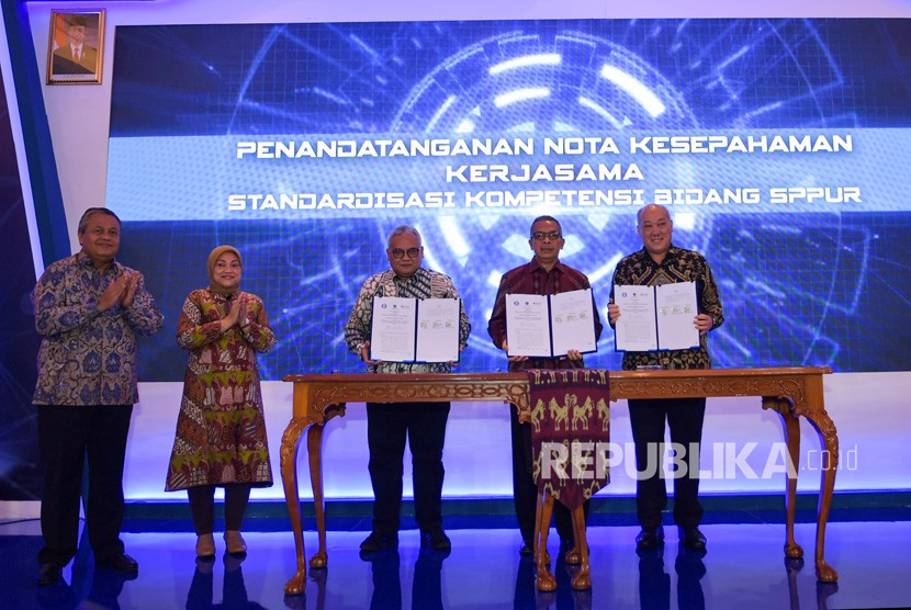 Gubernur Bank Indonesia (BI) Perry Warjiyo (kiri) dan Menteri Ketenagakerjaan Ida Fauziyah (kedua kiri) menyaksikan Deputi Gubernur BI Sugeng (kedua kanan), Dirjen Pembinaan Pelatihan dan Produktivitas Kemenaker Bambang Satrio Lelono (ketiga kiri) dan Ketua Badan Nasional Sertifikasi Profesi (BNSP) Kunjung Masehat (kanan) menunjukkan Nota Kesepahaman (MoU) yang sudah ditandatangani di Jakarta, Senin (9/3/2020).