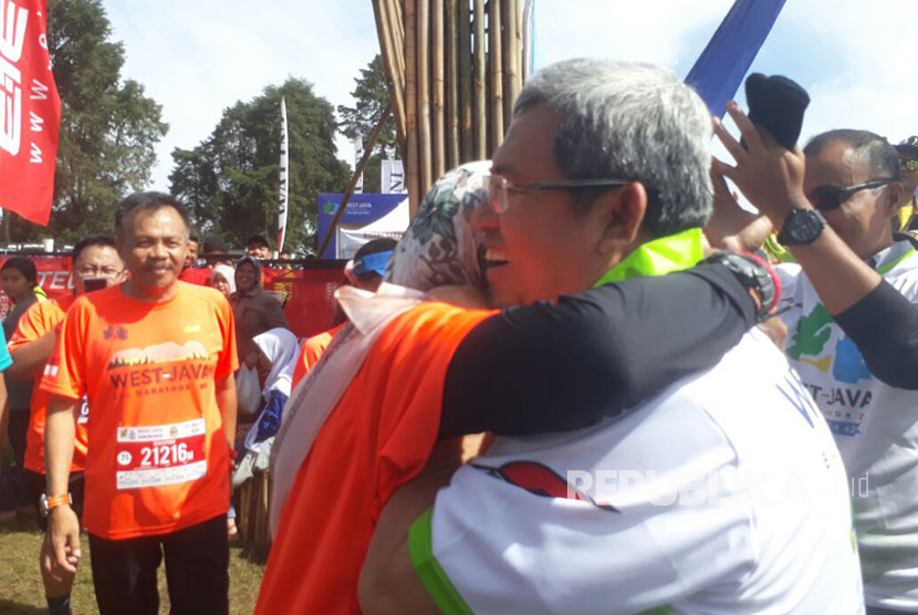 Gubernur Jawa Barat, Ahmad Heryawan menyambut Istrinya, Netty Heryawan yang finish di kategori 10K West Java Eco Marathon, Ahad (15/10).