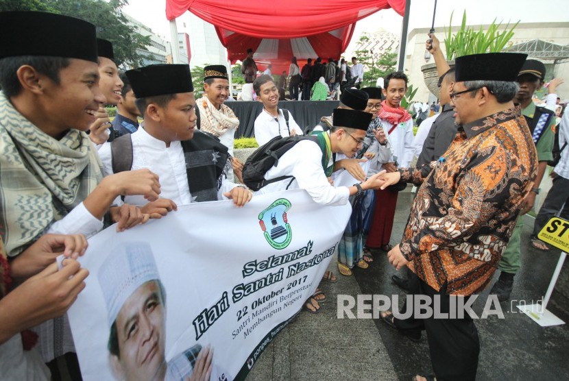 Gubernur Jawa Barat Ahmad Heryawan menyapa para santri usai peringatan Hari Santri Nasional 2017 Tingkat Jawa Barat, di halaman Masjid Raya Provinsi Jawa Barat, Alun-alun Kota Bandung, Kamis (26/10).