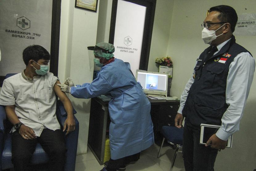 Gubernur Jawa Barat Ridwan Kamil (kanan) melihat petugas kesehatan melakukan simulasi vaksin COVID-19 di Puskesmas Tapos, Depok, Jawa Barat.
