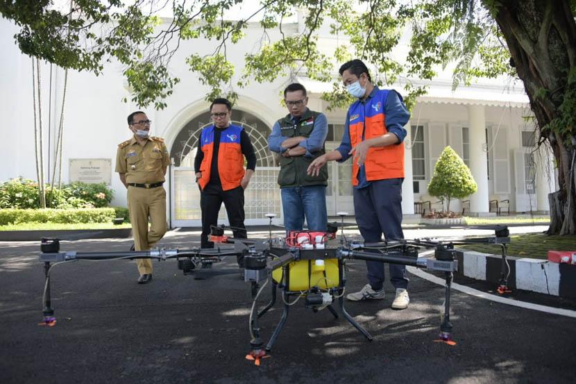 Gubernur Jawa Barat Ridwan Kamil, mengamati drone drone disinfektan untuk melawan dan mencegah penyebaran virus Corona atau Covid-19 yang dikembangkan Komite Nasional Pemuda Indonesia (KNPI) Jabar, di Gedung Pakuan, Kota Bandung, Selasa (31/3). 