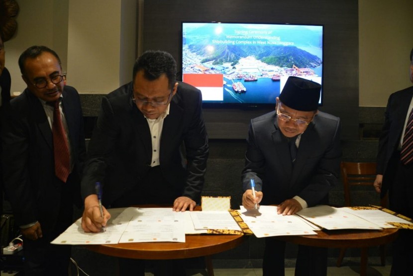 Gubernur NTB Zulkieflimansyah (kiri) dan Bupati Lombok Utara Najmul Akhyar (kanan) saat menandatangani nota kesepahaman proyek Global Hub Bandar Bandar Kayangan, Ahad (4/7).
