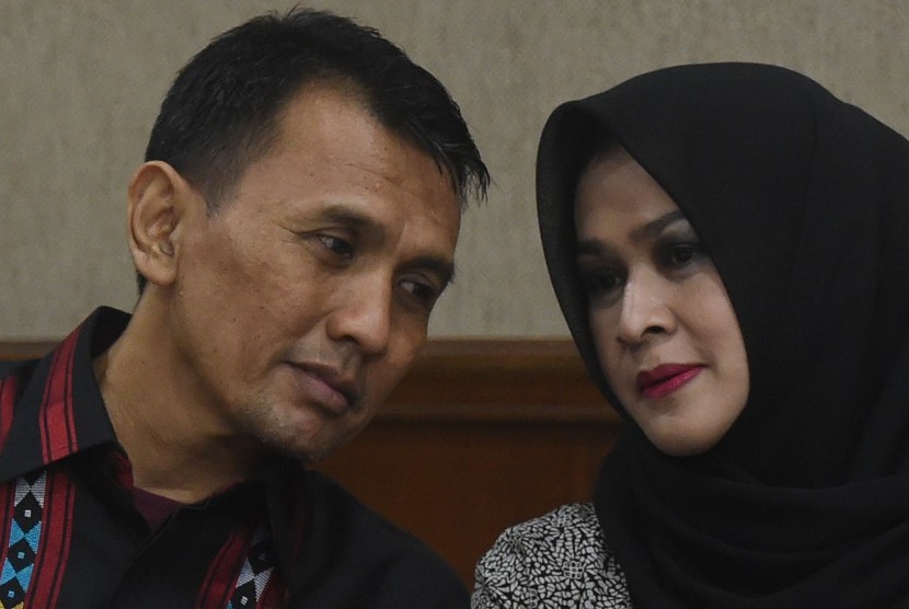 Gubernur Sumatera Utara nonaktif Gatot Pujo Nugroho (kiri) berbincang dengan istrinya Evy Susanti saat persidangan di Pengadilan Tipikor, Jakarta, Rabu (13/1).