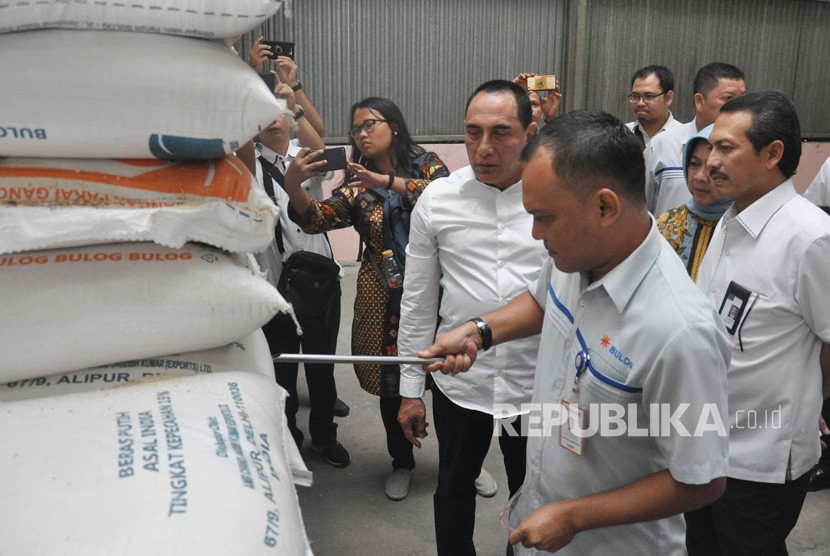 Gubernur Sumut Edy Rahmayadi (tengah) menyaksikan petugas Bulog mengambil sampel beras saat melakukan sidak bahan pangan pokok di gudang penyimpanan Bulog Medan, Sumatera Utara. Bulog Sumut menyebut pembelian beras petani dengan harga komersial