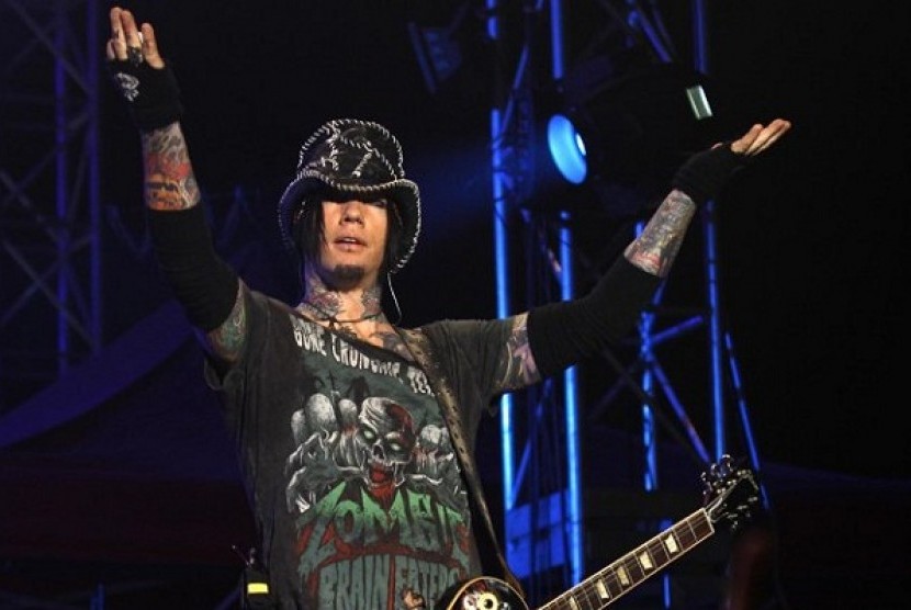 Guns N' Roses guitarist DJ Ashba reacts to the crowd as he performs during a concert in Bangalore, India. 