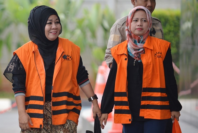 Hakim Pengadilan Negeri Tipikor Bengkulu nonaktif Dewi Suryana (kanan) dan PNS lingkungan Pemkot Bengkulu yang diduga sebagai penyuap Syuhadatul Islamy bersiap menjalani pemeriksaan di Gedung KPK Jakarta, Selasa (19/9).