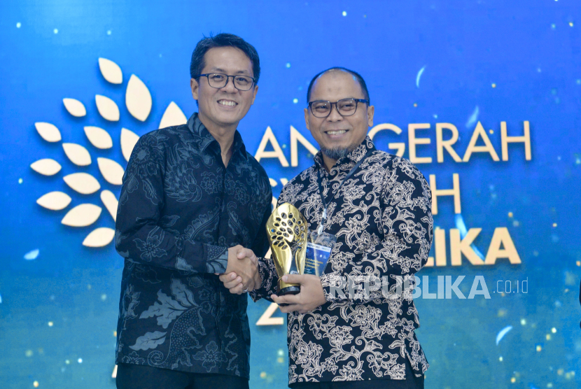 Head of Sharia Business Development & Product Solution Bank Jago, Agung Lesmana (kanan) menerima trofi Anugerah Syariah Republika (ASR) 2025 yang diserahkan oleh Pemimpin Redaksi Republika Andi Muhyiddin.