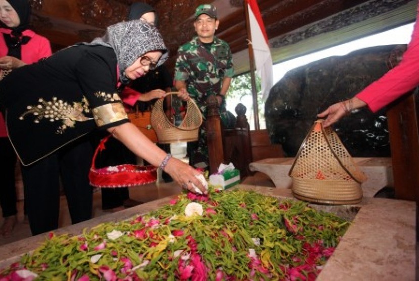 Ibunda Presiden Joko Widodo Sujiatmi Notomiharjo (kiri) didampingi Komandan Kodim 0808/Blitar Letkol Inf Kris Bianto (kanan) menabur bunga di pusara Makam Presiden Soekarno saat berziarah di Makam Presiden Soekarno di Blitar, Jawa Timur, Sabtu (14/4). Selain berkunjung ke Perpustakaan Nasional Bung Karno, Ibunda Jokowi juga mengunjungi Museum Istana Gebang, serta berziarah ke Makam Presiden Soekarno. 