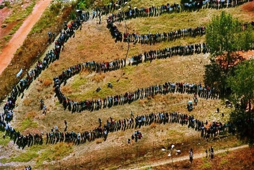 In this April 27, 1994, file photo, a long line of people wait outside the polling station in Soweto to vote in South Africa's first all-race elections. Nelson Mandela then emerged as the first black president in the country. (File photo)